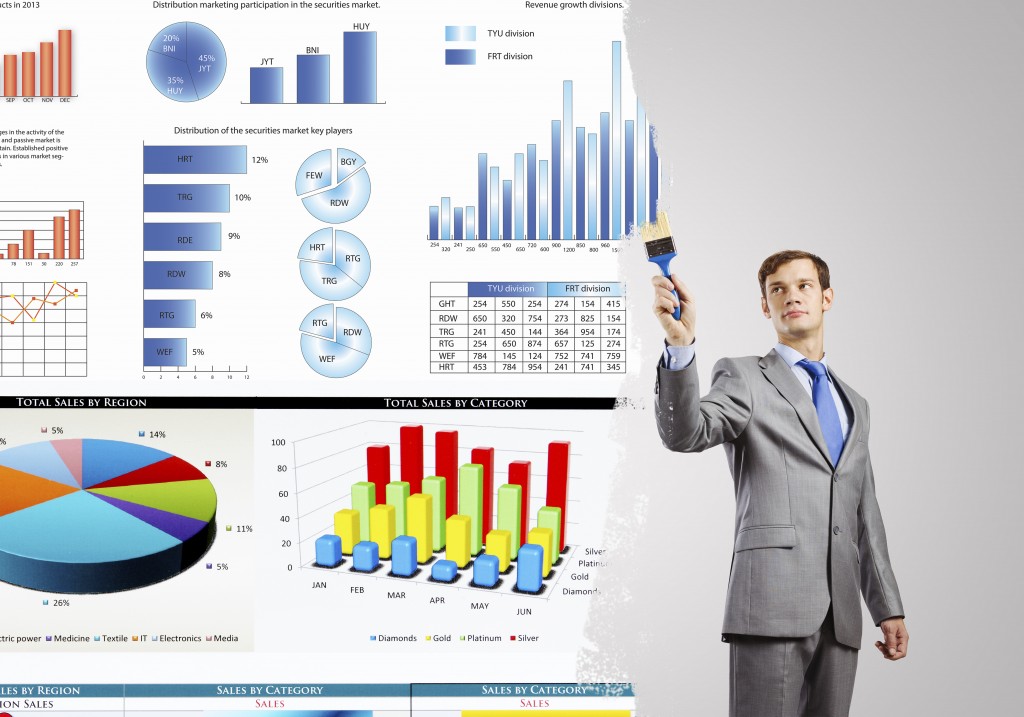 Young businessman painting graphs and diagrams with brush